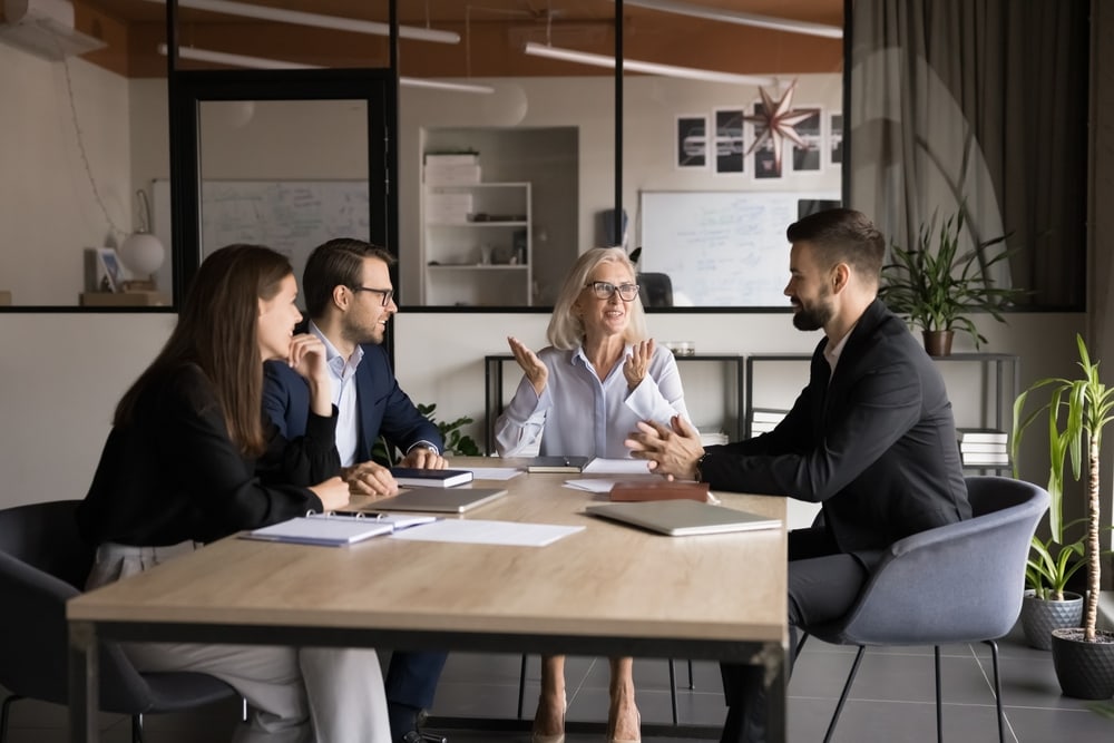 Senior,Company,Owner,Woman,Talking,To,Team,Of,Younger,Managers people in a meeting